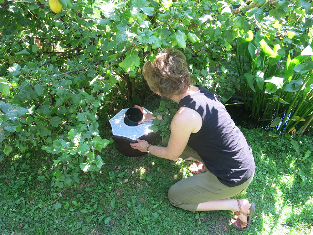 Photo: © 2018, Biogents AG. A home owner is inspecting the catch bag of a Biogents BG-Mosquitaire trap. This trap for home use is as good as scientists’ gold standard tiger mosquito trap, the BG-Sentinel.